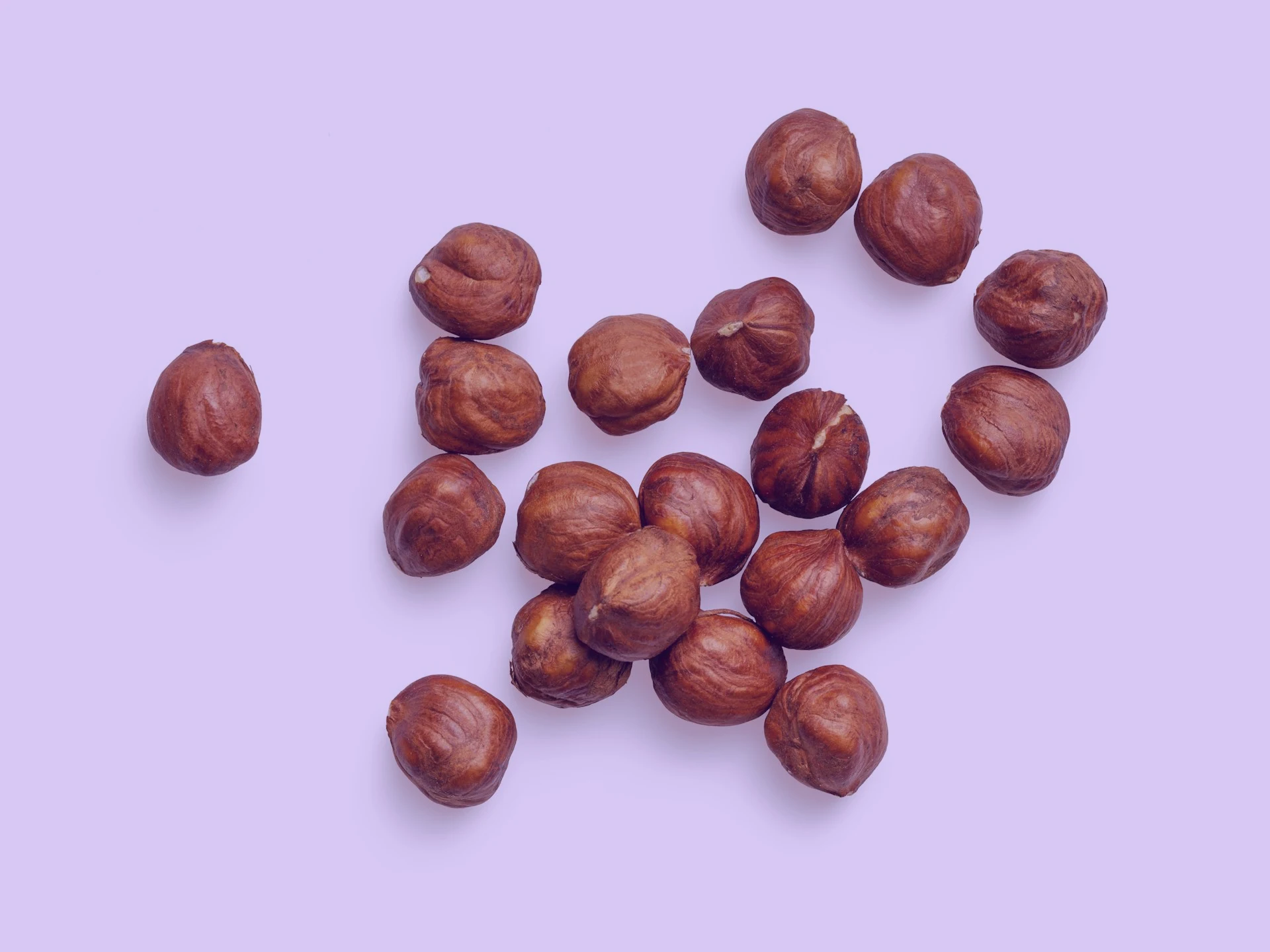 brown almond nuts on white surface
